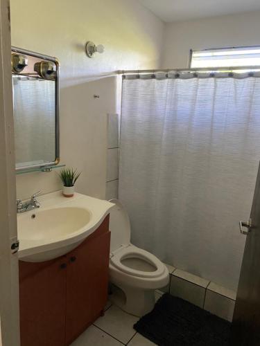 a bathroom with a toilet and a sink and a shower at Natural Village #1,2,3 & 5 in San Juan