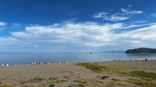 a group of people on a beach near the water at Al Saliceto Hotel in Patti