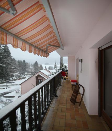 a balcony of a house with snow on the ground at Appartement Adélaïde in Le Hohwald