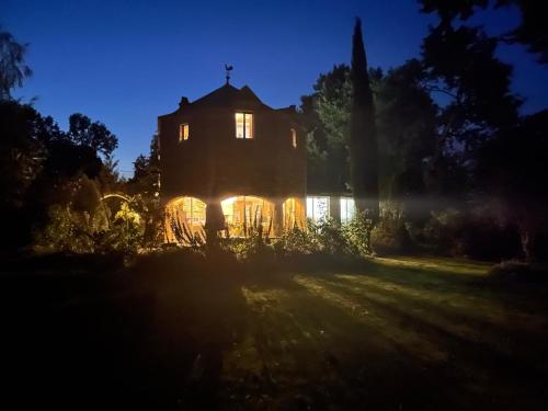 an old house at night with the lights on at Le Clos Saint Fiacre in Carentoir