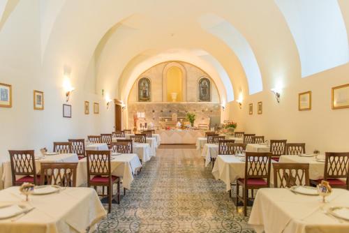 a banquet hall with tables and chairs in a building at San Paolo Al Convento in Trani