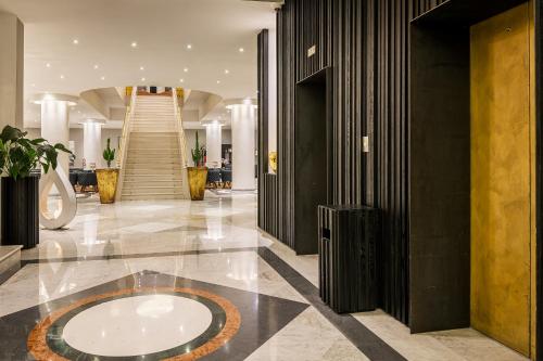 a lobby with a large circle on the floor of a building at Mec Paestum Hotel in Paestum