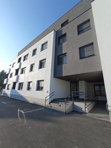 a large building with a parking lot in front of it at FIOLICA in Zaprešić