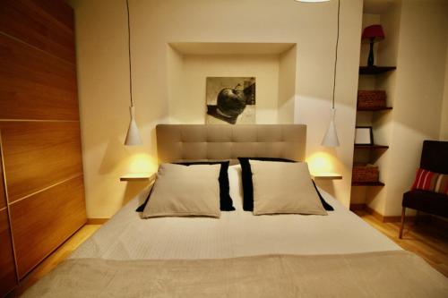 Appartement chaleureux et cocooning à Barr - Escapade chez Valentine في بار: غرفة نوم بسرير ابيض كبير مع وسادتين