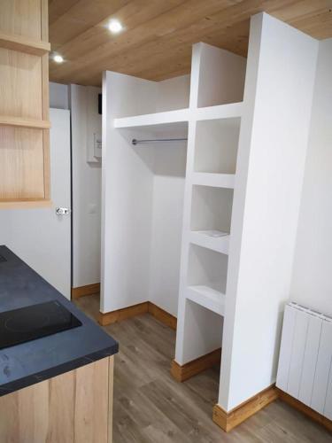 - une cuisine avec des étagères blanches dans une pièce dans l'établissement Charming Studio With Balcony, à Mâcot La Plagne