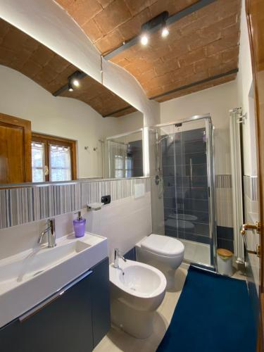 a bathroom with a sink and a toilet and a shower at Le Casette di Viola in Arezzo