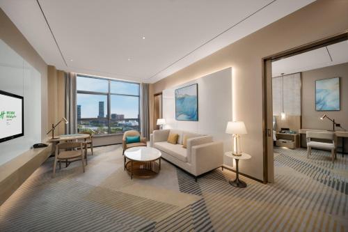 a living room with a couch and a table at Holiday Inn Fuyang by IHG in Fuyang