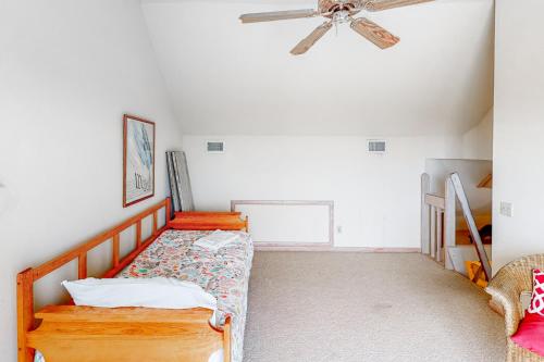 a bedroom with a bed and a ceiling fan at Dunluce #12-WW in Waves
