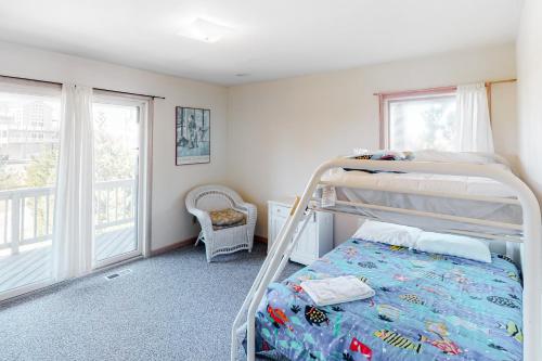 a bedroom with a bunk bed and a balcony at Dunluce #12-WW in Waves