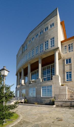 a large building with columns in front of it at Gran Hotel Los Abetos in Santiago de Compostela