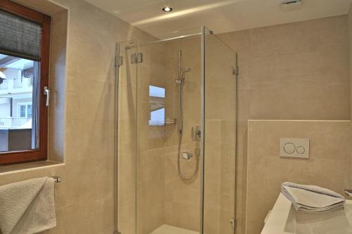 a shower with a glass door in a bathroom at Haus Hildegard in Gerlos