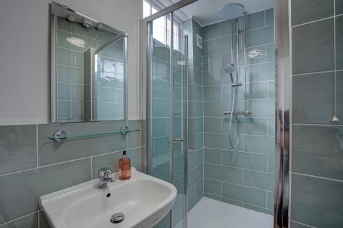 a bathroom with a sink and a shower at Mariners Hard, Cley-Next-The-Sea in Cley next the Sea