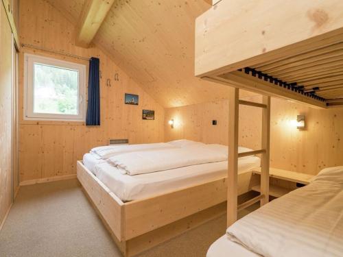 a bedroom with a bunk bed and a window at Wellness Chalet Bell a Mur in Murau