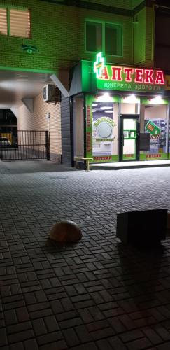 a donut sitting on the ground in front of a building at Апартаменты по Панаса Мирного. in Khmelʼnytsʼkyy