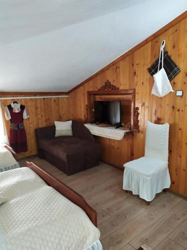 a living room with a bed and a couch at Gologanova house in Kalofer