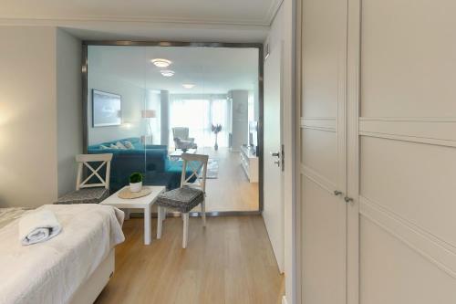 a bedroom with a bed and a living room at Hip riverview bestern in Szeged