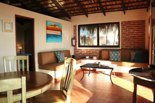 a living room with a table and a couch at Sukasa Bungalows in Loreto