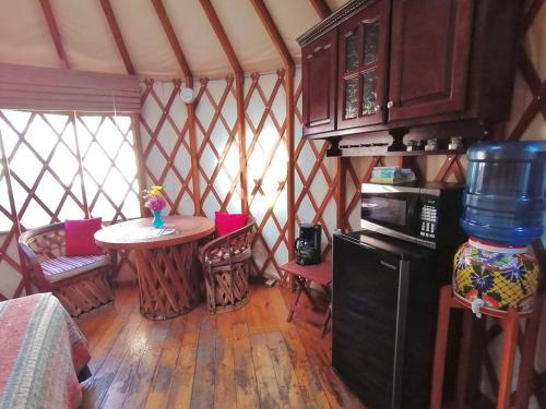 a room with a table and chairs in a yurt at Sukasa Bungalows in Loreto