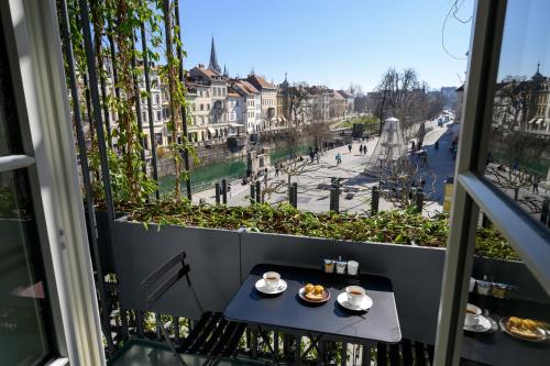 a balcony with a table with food on it at Zlata Ladjica Boutique Hotel in Ljubljana