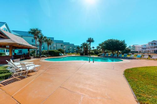 a swimming pool with chairs at Gulf Shores Plantation #1262 in Gulf Shores