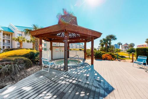 a gazebo with two chairs and a table at Gulf Shores Plantation #1262 in Gulf Shores