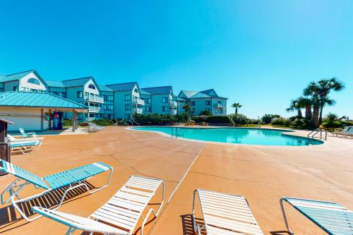 a resort with a swimming pool and lounge chairs at Gulf Shores Plantation #1262 in Gulf Shores