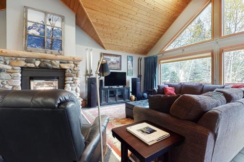 a living room with a couch and a fireplace at Lone Walker Home in Big Sky
