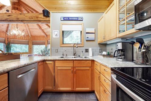 a kitchen with wooden cabinets and a counter top at Lone Walker Home in Big Sky