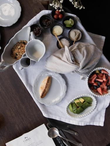 a table topped with plates of food on a table at CIRQA - Relais & Châteaux in Arequipa
