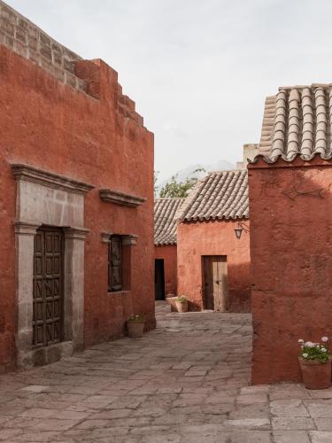 an alley between two red brick buildings at CIRQA - Relais & Châteaux in Arequipa