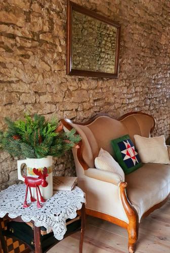 a living room with a couch and a table at Babie Lato b&b in Uniejow