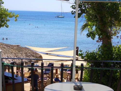 a view of the beach with a boat in the water at Hercules Sea Front Studios in Katelios