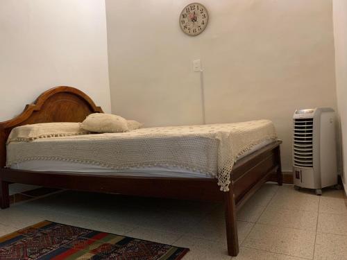 a bed with a teddy bear on it in a bedroom at Casa Grande in Medellín
