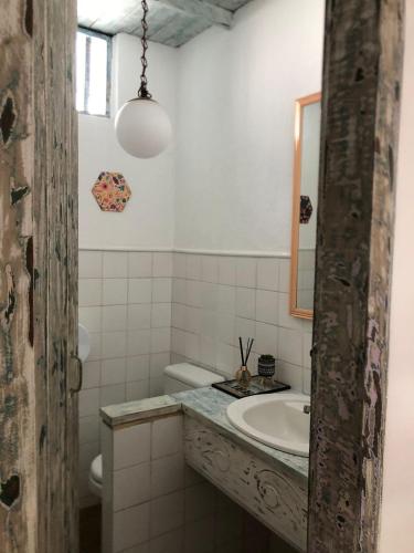 a bathroom with a sink and a mirror at Pousada Cores da Passarela - Sob nova direção in Porto Seguro