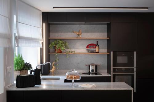 a kitchen with black cabinets and a counter top at Camere d'Aria in Locana