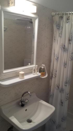 a bathroom with a sink and a mirror at Natura Studios in Loutra Edipsou