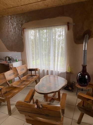 a room with a table and chairs and a window at Cabañas Los Abuelos in Zacatlán