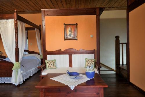 a bedroom with a bed and a table with a bowl on it at Kivotos Epavlis in Prespes