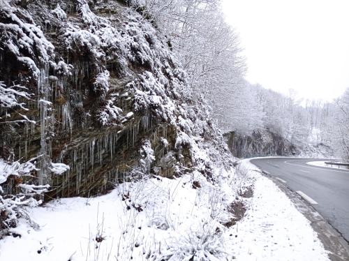 a road covered in snow next to a fence at Les Ecureuils in Revin