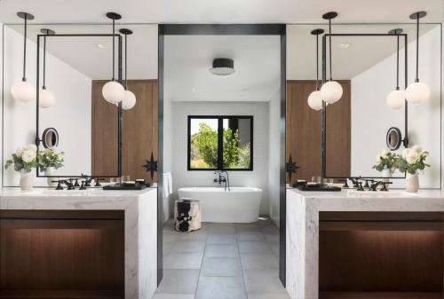 a bathroom with two sinks and a bath tub at Four Seasons Resort Napa Valley in Calistoga