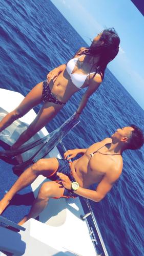 two women in bathing suits on a boat in the water at Summer Vibes Beach Front in Rasdu