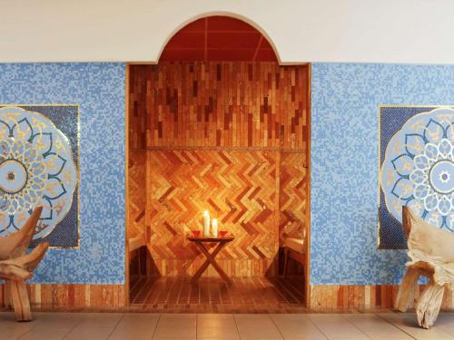 a room with a table with a lit candle at Sofitel Golfe d'Ajaccio Thalassa Sea & Spa in Ajaccio