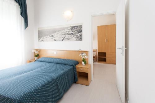 Ένα ή περισσότερα κρεβάτια σε δωμάτιο στο Hotel Marina
