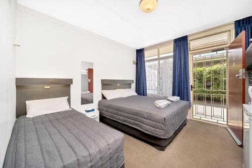 Ένα ή περισσότερα κρεβάτια σε δωμάτιο στο Central Wangaratta Motel