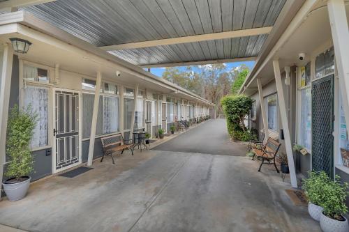 an empty hallway of a building with benches and chairs at Central Wangaratta Motel in Wangaratta
