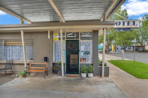 a building with a bench in front of it at Central Wangaratta Motel in Wangaratta