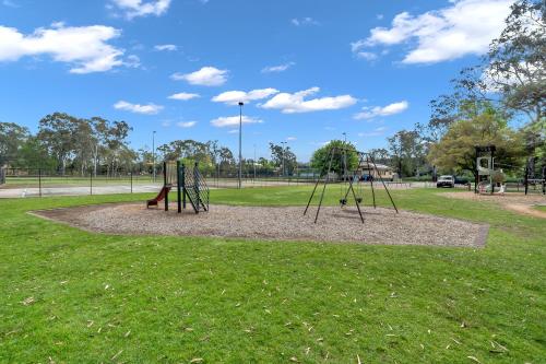 a park with a playground with swings at Central Wangaratta Motel in Wangaratta