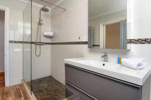 a bathroom with a sink and a shower at Casa Patricia in Jávea