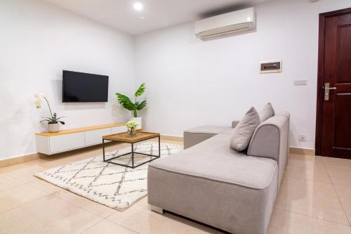 a living room with a couch and a tv at MekongView 6 CondoTel in Phnom Penh