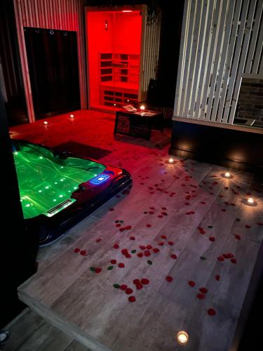 a room with a pool table and red lights at La suite Grenoble spa jacuzzi et sauna privatif in Grenoble